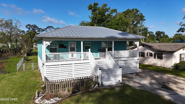 1314 Mcclelland Ave, Port St Joe, FL 32456 - view of front of home with stairs, a porch, and metal roof