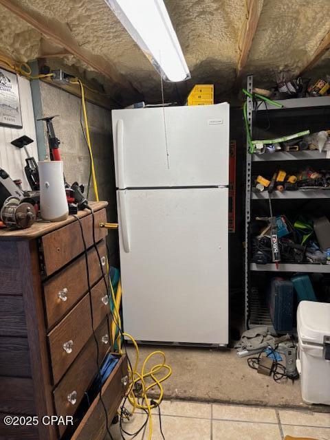 1314 Mcclelland Ave, Port St Joe, FL 32456 - below grade area with freestanding refrigerator and tile patterned floors