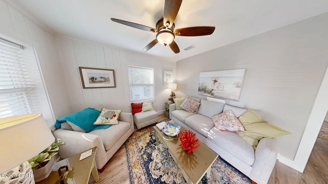 1314 Mcclelland Ave, Port St Joe, FL 32456 - living room with wood finished floors, ceiling fan, baseboards, and crown molding