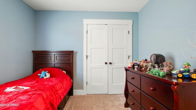 bedroom with light colored carpet and a closet