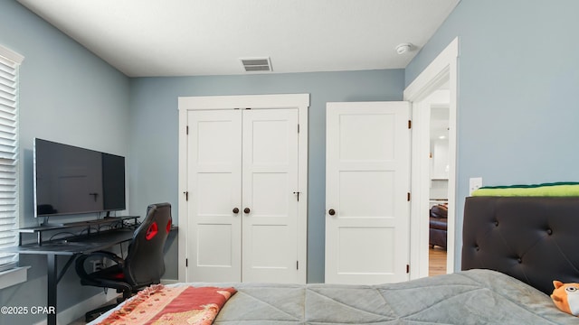bedroom featuring visible vents and a closet