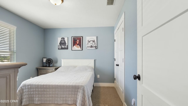 bedroom featuring visible vents, baseboards, and carpet
