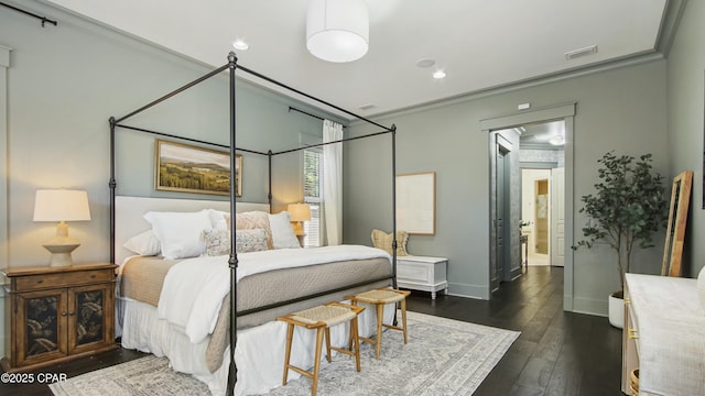 bedroom with recessed lighting, ornamental molding, dark wood finished floors, and baseboards