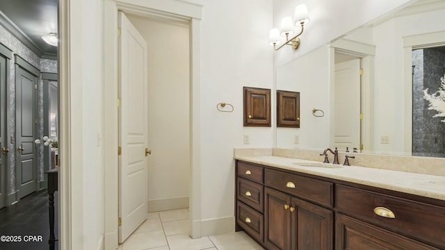 bathroom featuring tile patterned flooring, vanity, and baseboards