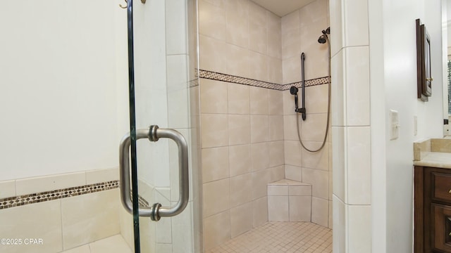 full bathroom with a stall shower and vanity