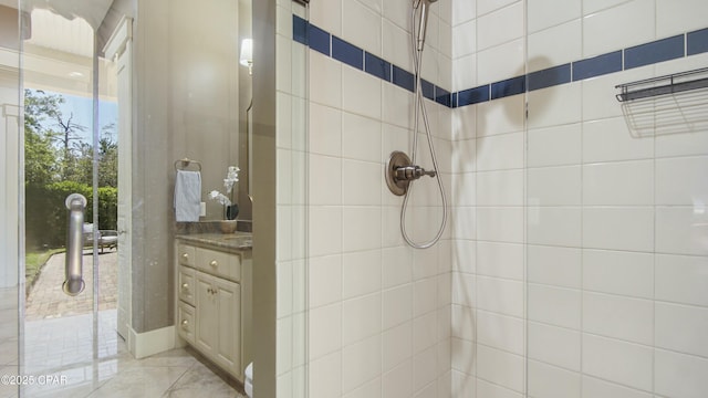 full bathroom with vanity and tiled shower