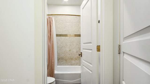 full bath featuring toilet and shower / bath combination with curtain