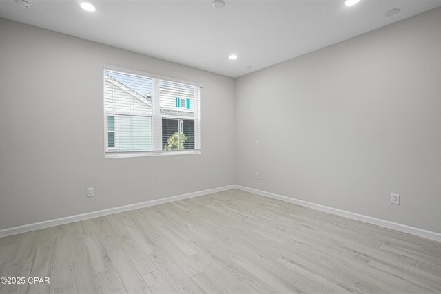 empty room featuring light wood-style flooring, baseboards, and recessed lighting