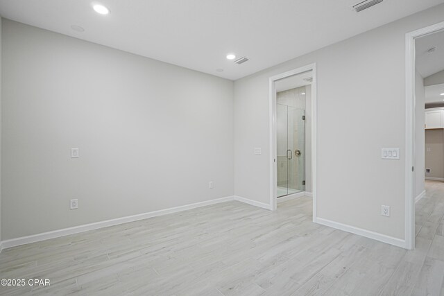 interior space with light wood-style floors, baseboards, visible vents, and recessed lighting