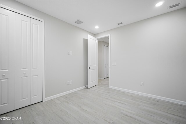 unfurnished bedroom with light wood-style floors, baseboards, visible vents, and recessed lighting