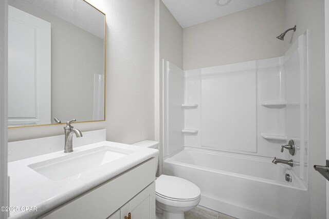 bathroom featuring vanity, shower / tub combination, and toilet