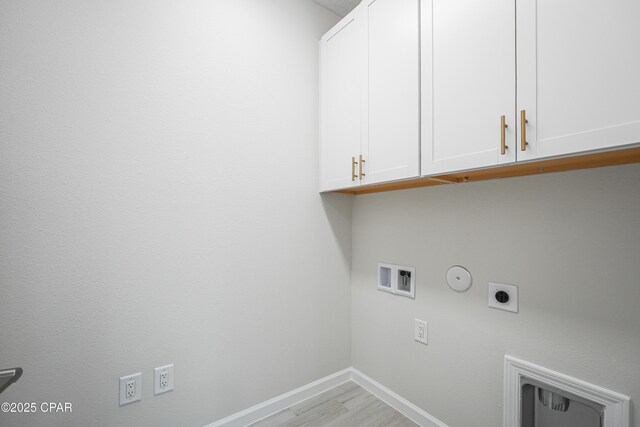 washroom featuring baseboards, washer hookup, hookup for a gas dryer, hookup for an electric dryer, and cabinet space