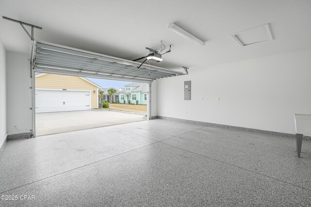garage with a garage door opener, baseboards, and electric panel