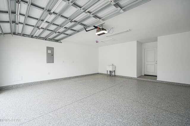 garage with a sink, baseboards, a garage door opener, and electric panel