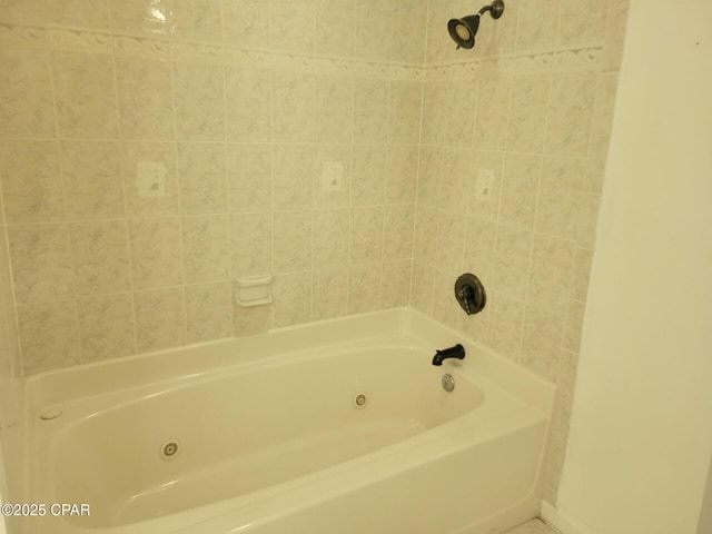 bathroom featuring a combined bath / shower with jetted tub and baseboards