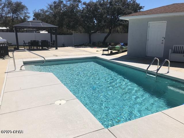 view of swimming pool with a fenced backyard, a gazebo, a fenced in pool, and a patio
