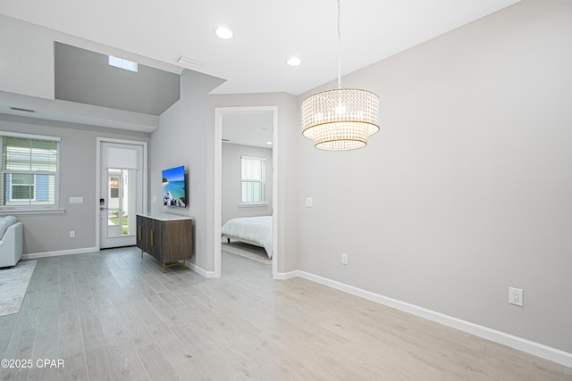 interior space featuring light wood finished floors, baseboards, a notable chandelier, visible vents, and recessed lighting