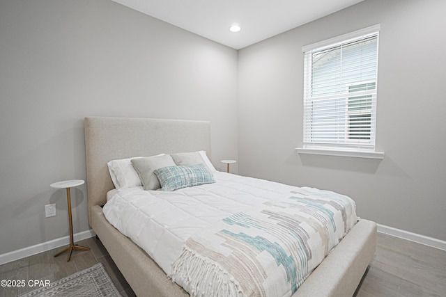 bedroom featuring recessed lighting, wood finished floors, and baseboards