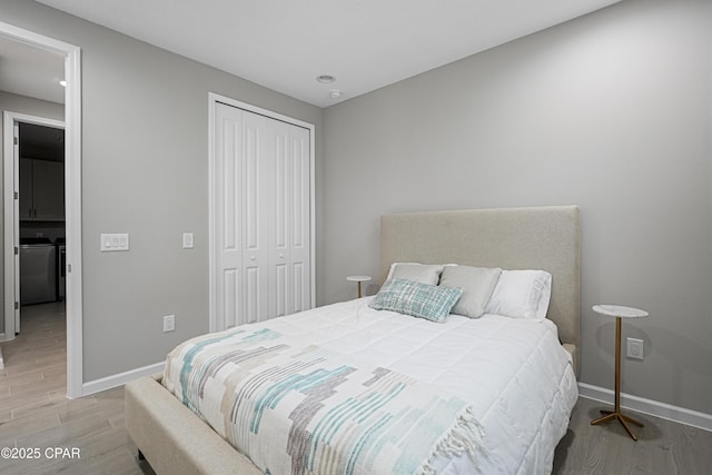 bedroom with recessed lighting, baseboards, wood finished floors, and a closet