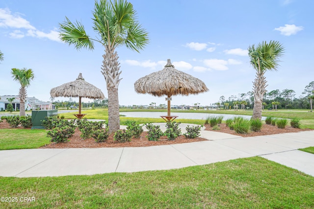 view of home's community with a lawn, a gazebo, and a water view
