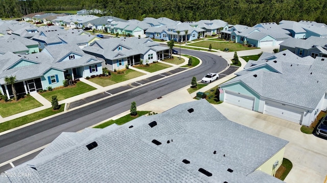 birds eye view of property featuring a view of trees and a residential view