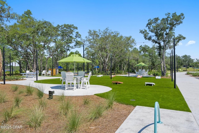 view of property's community with a yard and playground community