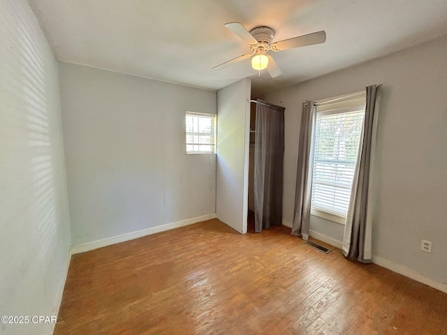 1229 Harrison Ave, Chipley, FL 32428 - unfurnished bedroom with light wood finished floors, visible vents, baseboards, and ceiling fan