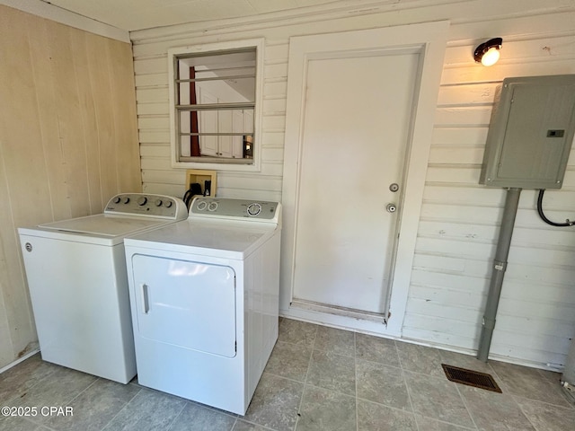 1229 Harrison Ave, Chipley, FL 32428 - washroom with visible vents, electric panel, laundry area, wood walls, and washing machine and dryer