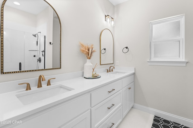 1106 E 3rd St, Panama City, FL 32401 - bathroom with a shower stall, baseboards, double vanity, and a sink
