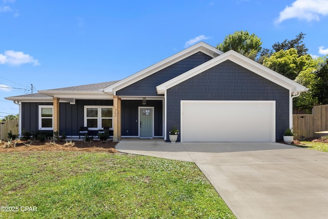 1106 E 3rd St, Panama City, FL 32401 - ranch-style home with board and batten siding, driveway, fence, a garage, and a front yard