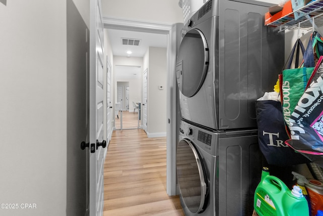 1106 E 3rd St, Panama City, FL 32401 - laundry area with baseboards, light wood finished floors, visible vents, laundry area, and stacked washer / drying machine