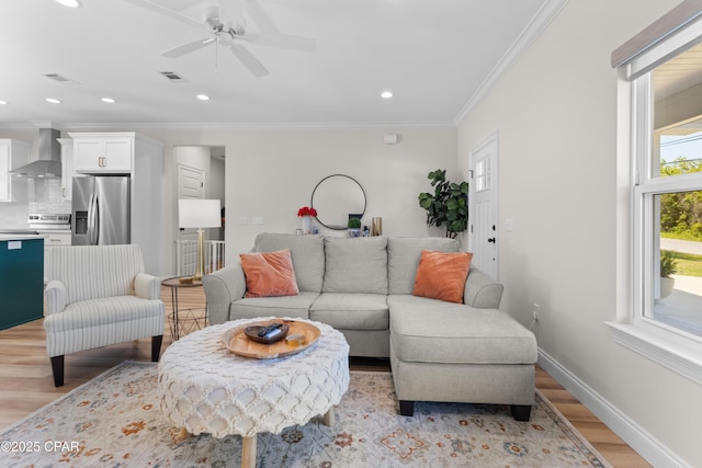 1106 E 3rd St, Panama City, FL 32401 - living room featuring a ceiling fan, ornamental molding, light wood-type flooring, and visible vents