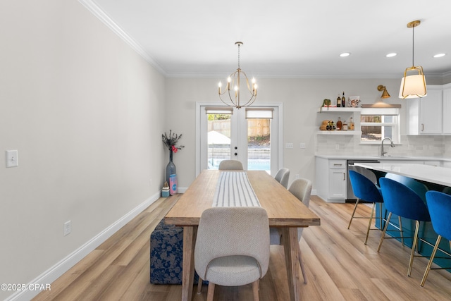 1106 E 3rd St, Panama City, FL 32401 - dining space with french doors, ornamental molding, baseboards, a notable chandelier, and light wood-style floors