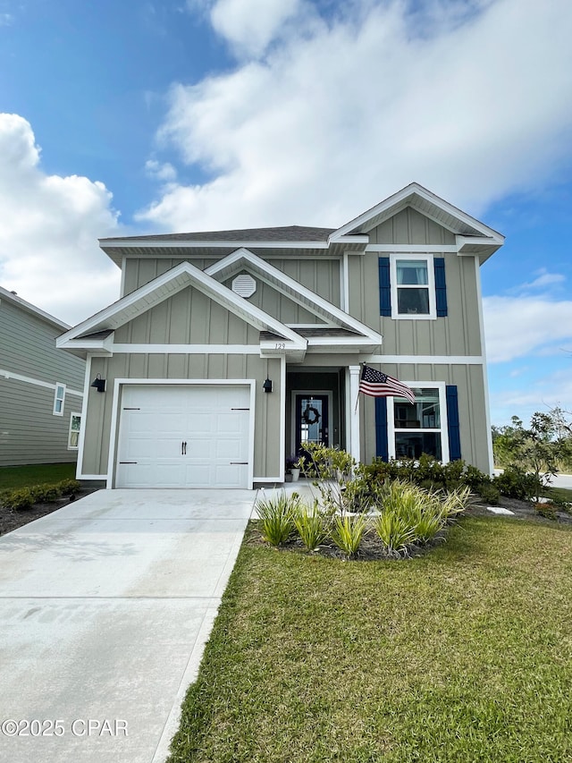 view of front of home featuring a garage, board and batten siding, driveway, and a front yard