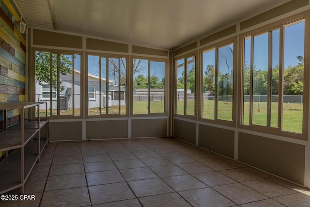 unfurnished sunroom with a wealth of natural light and tile patterned flooring