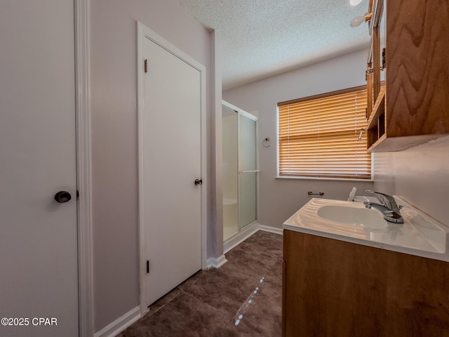 2613 Indian Springs Rd, Marianna, FL 32446 - bathroom with a textured ceiling, tile patterned flooring, a sink, a stall shower, and baseboards