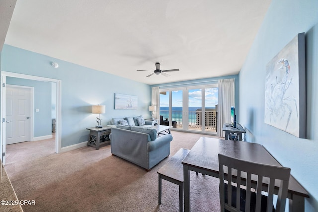 living room featuring carpet, a ceiling fan, and baseboards