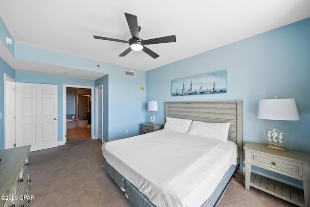 bedroom with carpet flooring, baseboards, ceiling fan, and connected bathroom
