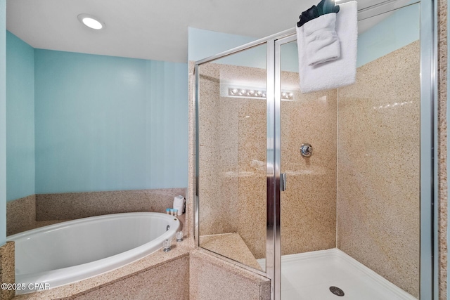 bathroom featuring a bath and a stall shower
