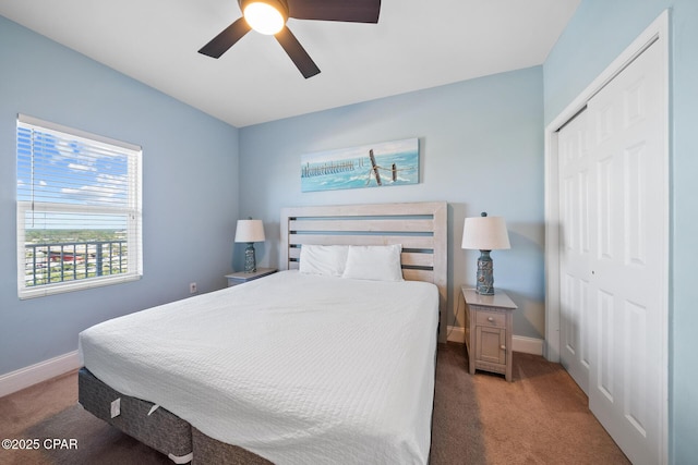 carpeted bedroom featuring a closet, baseboards, and ceiling fan