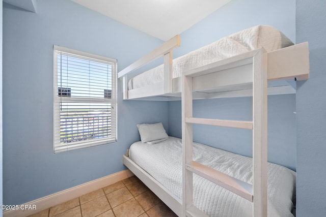 bedroom featuring baseboards and tile patterned floors