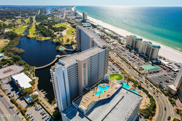 drone / aerial view of a nearby body of water and a pool