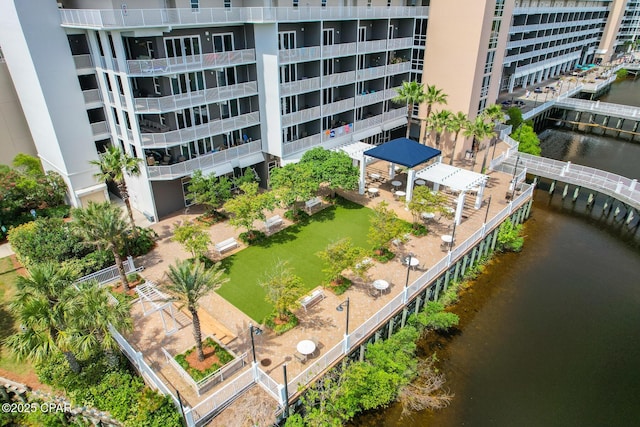 drone / aerial view of a nearby body of water and apartment complex / building
