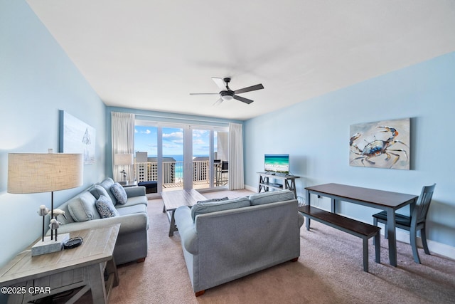 carpeted living room with ceiling fan