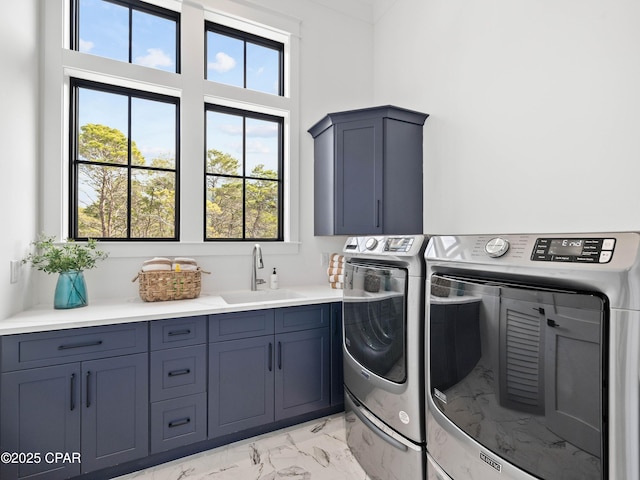 clothes washing area with marble finish floor, independent washer and dryer, a sink, and cabinet space
