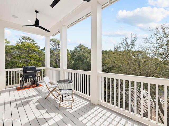 deck with grilling area and a ceiling fan