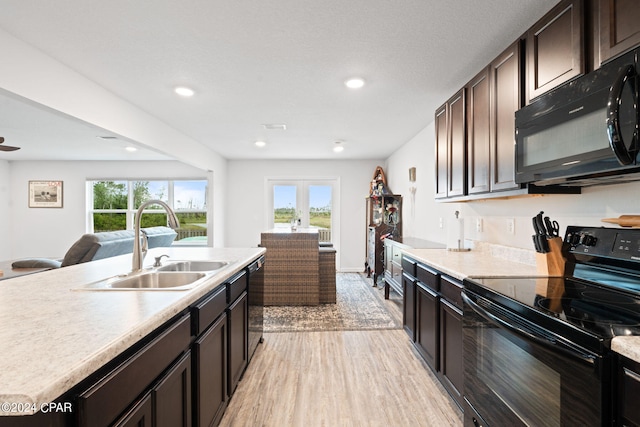 3946 Whitehead Blvd, Panama City, FL 32404 - kitchen with a sink, light wood-type flooring, a wealth of natural light, black appliances, and open floor plan
