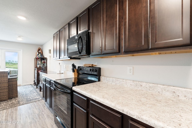 3946 Whitehead Blvd, Panama City, FL 32404 - kitchen featuring light countertops, dark brown cabinets, light wood-style floors, baseboards, and black appliances