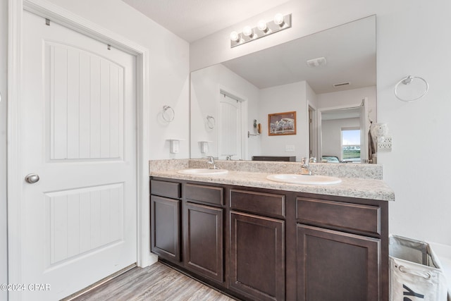 3946 Whitehead Blvd, Panama City, FL 32404 - bathroom with visible vents, wood finished floors, a sink, and double vanity