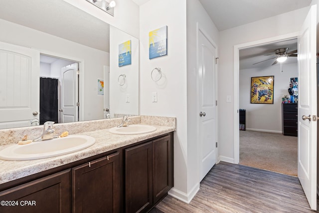 3946 Whitehead Blvd, Panama City, FL 32404 - bathroom with double vanity, baseboards, wood finished floors, and a sink